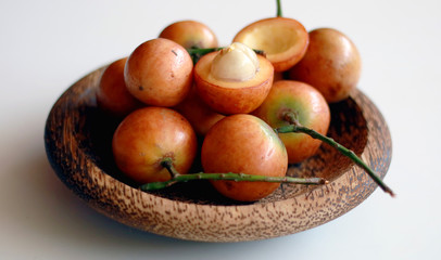 Menteng fruit or Baccaurea racemosa on wood plate.