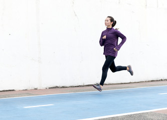 White woman running on track