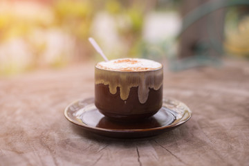 Cappuccino coffee on old wooden table