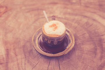 Cappuccino coffee on old wooden table