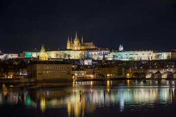 Night view of the famous Charles Bridge with the Vltava river from the old district of the city of Prague. Czech Republic