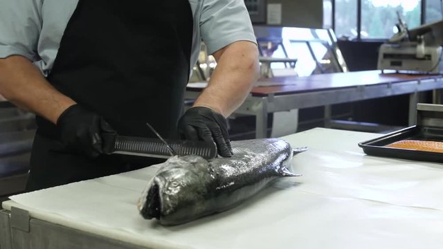 Butcher filleting a fish