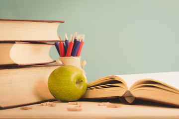 still life of old books on the desk,table with light green background.