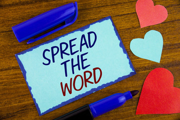 Writing note showing  Spread The Word. Business photo showcasing Run advertisements to increase store sales many fold written on Sticky note paper on the wooden background Hearts next to it