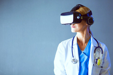 Female doctor wearing virtual reality glasses isolated on white background.