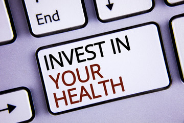 Handwriting text writing Invest In Your Health. Concept meaning Spend money in personal healthcare Preventive Tests written on White Keyboard Key with copy space. Top view.