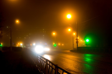 Fototapeta premium City road in the evening during a thick fog 