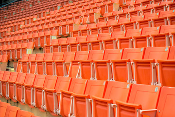 Many chairs in football stadium.