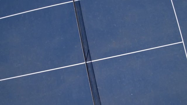 Two young people playing tennis outdoors