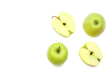 green apples with slices isolated on white background. top view