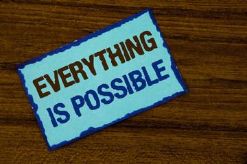 Text sign showing Everything Is Possible. Conceptual photo All you think or dream can become true Optimistic written on Sticky note paper on the Wooden background.