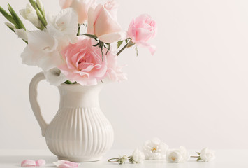 pink and white flowers in vase on white background