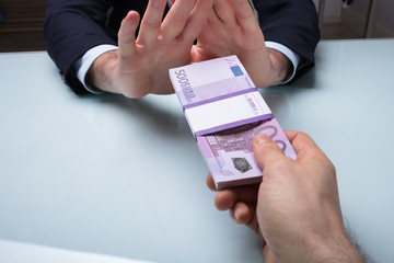 Close-up Of A Businessman's Hand Refusing Bribe