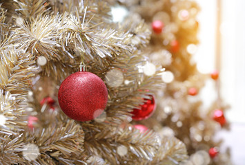 Christmas tree with red ball with bokeh background.