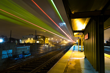 Train passing its station at night