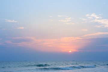 Sunset at the beach and with fishing boats and cargo ships.