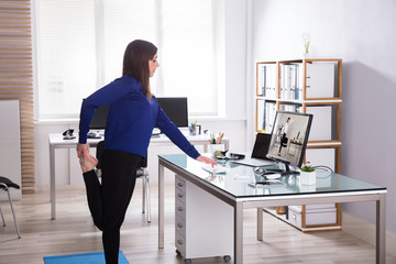 Young Businesswoman Doing Yoga