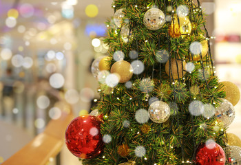 Christmas tree and bauble hanging decorations at winter season.