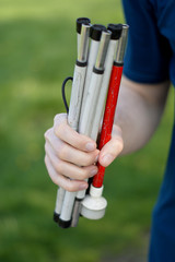 isolated hand of an blind young man hold a blind stick