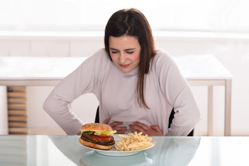Young Woman Suffering From Stomach Pain