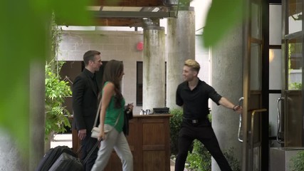 Doorman opening door for guests