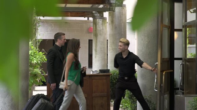 Doorman opening door for guests
