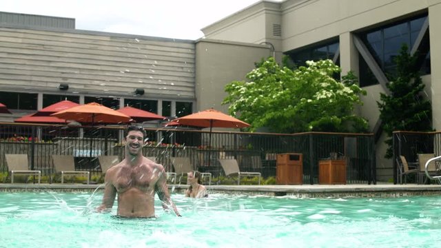 Family playing in a pool