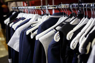 School clothes for boy and girl on hanger