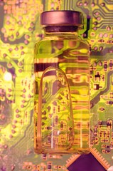 Vial with liquid on circuit board.