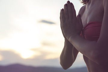 Fototapeta na wymiar Young woman practicing yoga on the tropical beach.