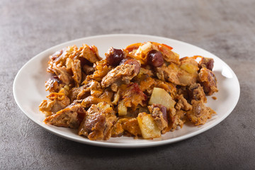 Omelette made from eggs, potatoes, sausages and tomato sauce