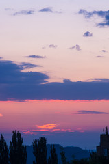 Landscape with dramatic light - beautiful golden sunset with saturated sky and clouds.
