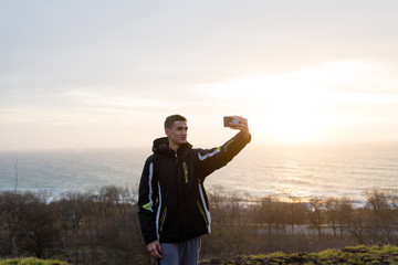 the traveler does selfie on the background of the sea