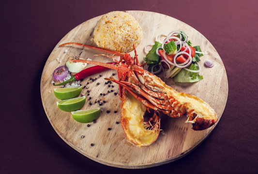 A Luxury Dish Of Lobster Roasted And Decorated With Many Items Of Vegetable