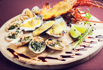 A luxury dish of lobster roasted and decorated with many items of vegetable