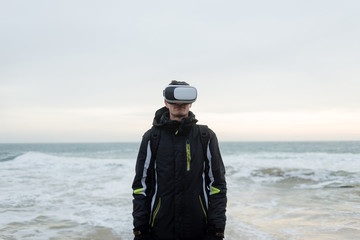 a man by the sea in virtual reality glasses