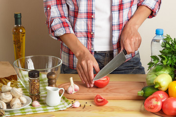 Woman cooks at the kitchen