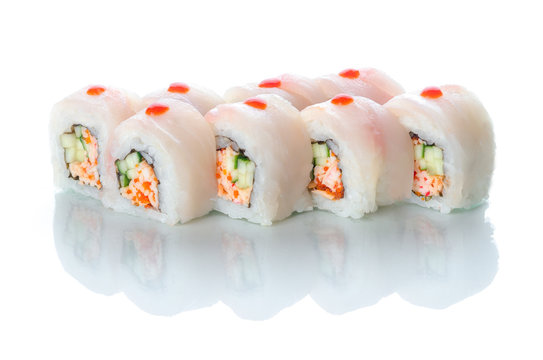 On white isolated background with reflection, sushi rolls red perch and snow crab uramaki white dragon
