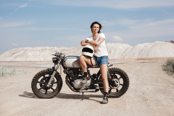 Fototapeta na wymiar Female on custom built cafe racer motorcycle
