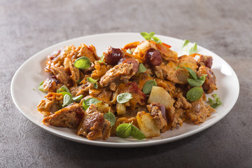Omelette made from eggs, potatoes, sausages and tomato sauce