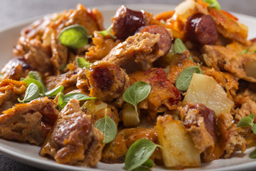 Omelette made from eggs, potatoes, sausages and tomato sauce