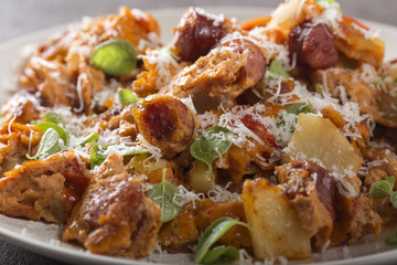 Omelette made from eggs, potatoes, sausages and tomato sauce