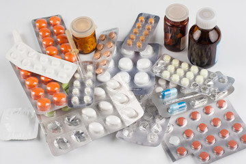 Medicine. Science. Multicolored tablets in different packages lying on the table