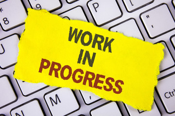 Text sign showing Work In Progress. Conceptual photo People is working right know to deliver expected results written on Tear Sticky note paper placed on White Keyboard. Top View.