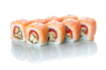 On white isolated background with reflection, sushi rolls with eel and salmon with Japanese mayonnaise droplets