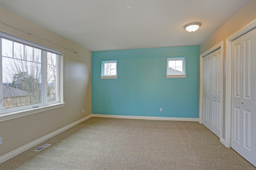 Light empty room interior with focus on a bright blue wall