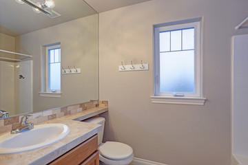 Obraz na płótnie Canvas Light bathroom interior with tiled top vanity cabinet
