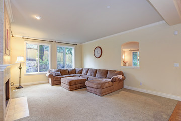 Spacious light living room features classic fireplace