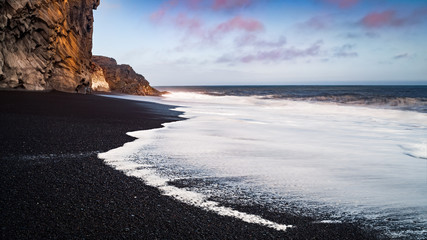 A long exposure seascape shot on a black sand beach in iceland - obrazy, fototapety, plakaty