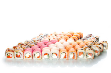 On white background isolated with reflection, sushi rolls Japanese cuisine beautiful lot set different